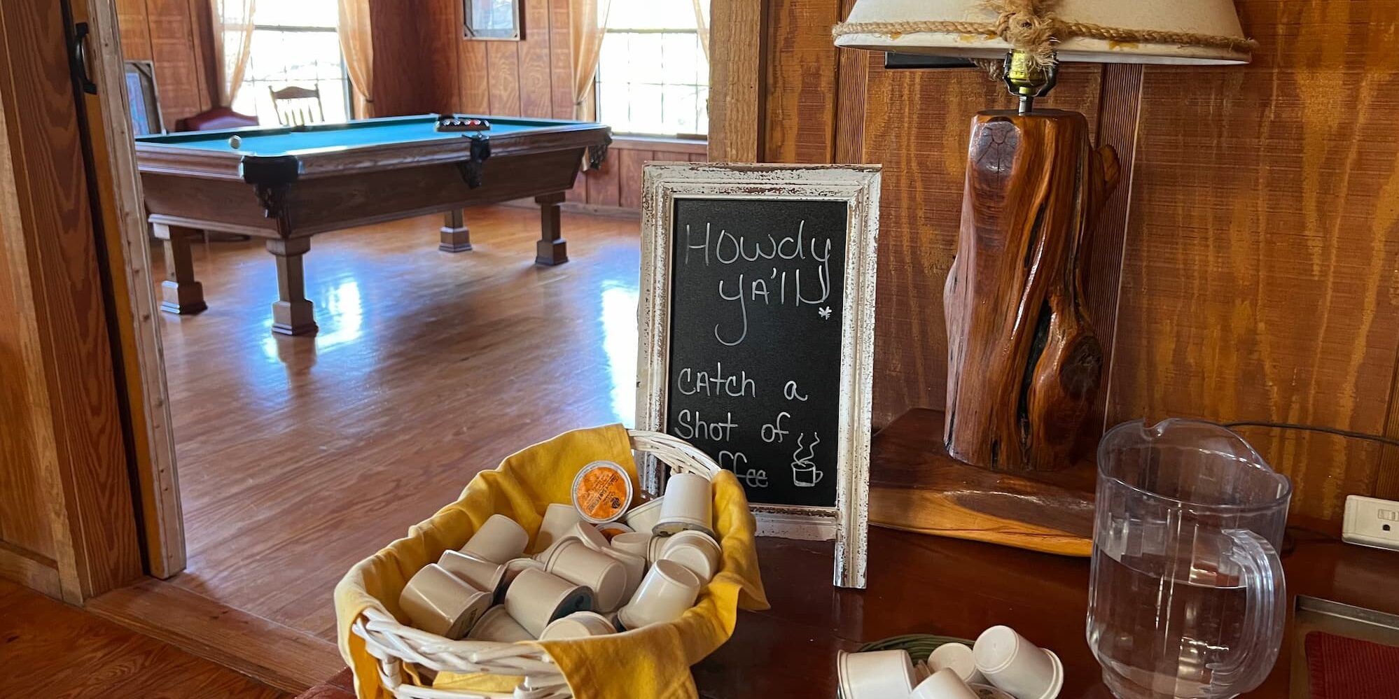 A small chalkboard sign welcomes guests on the counter of the coffee and tea area in the dining room